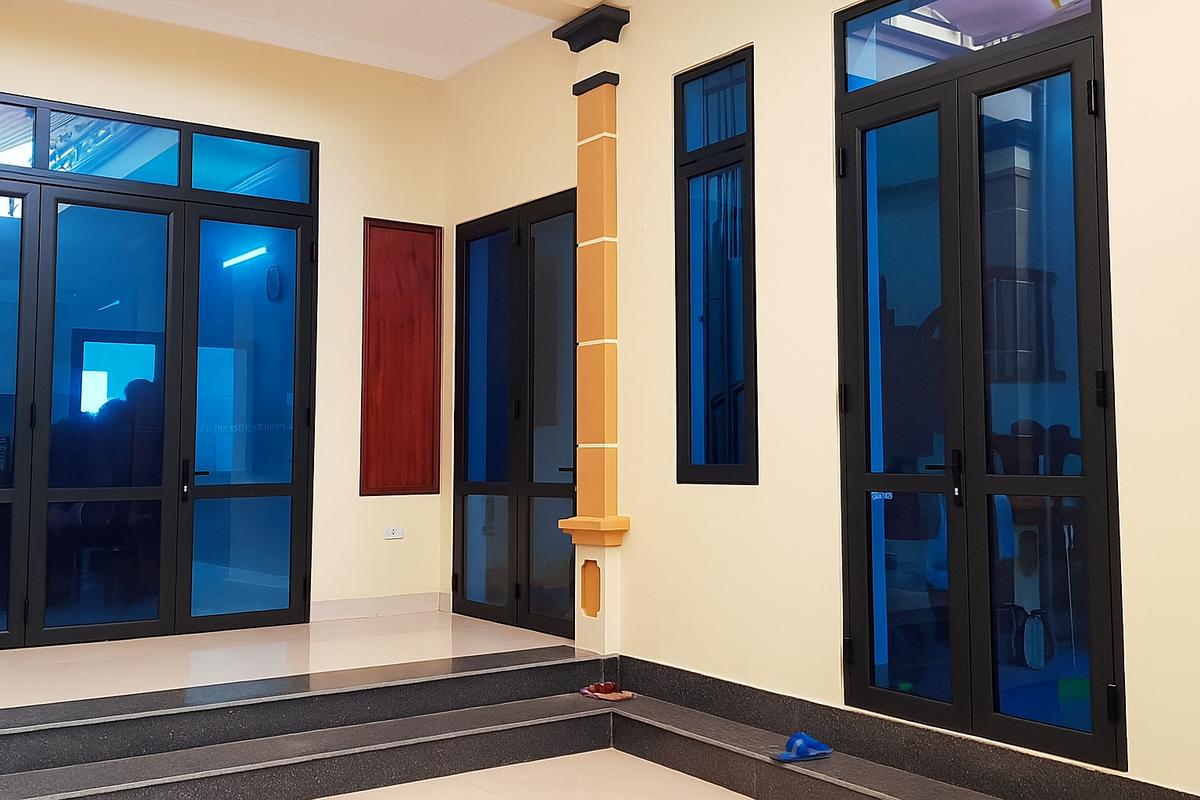 Bộ cửa nhôm kính với kính cường lực xanh đậm