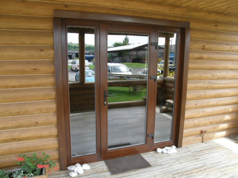 Cửa nhôm kính mặt tiền mở quay 1 cánh màu nâu