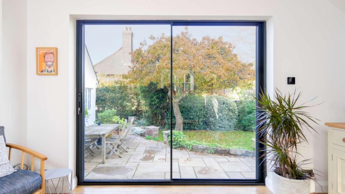 2-panel aluminum frame glass sliding door design between living and garden.