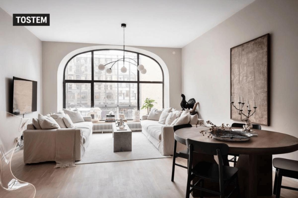 Large glass arch window design in India maximizes natural daylight.