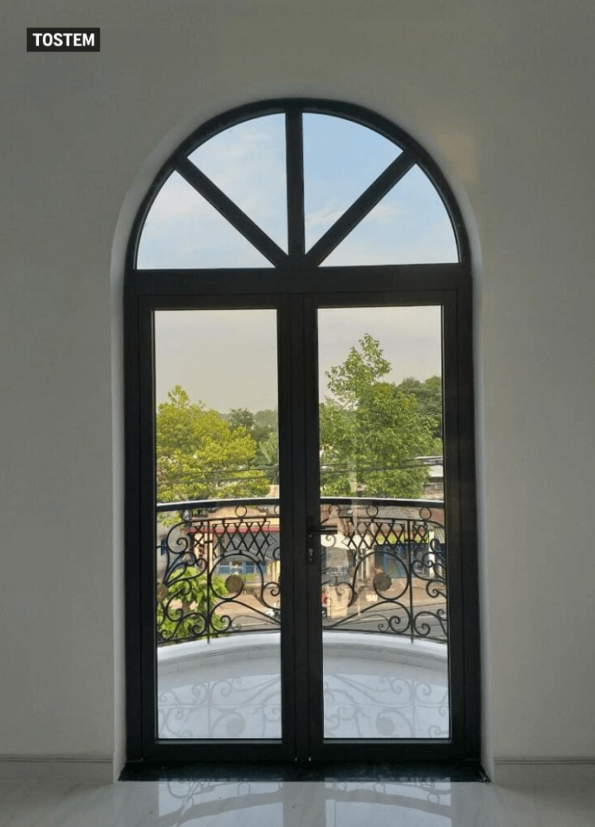 Structure of aluminium arch window design in India with frame and glass.